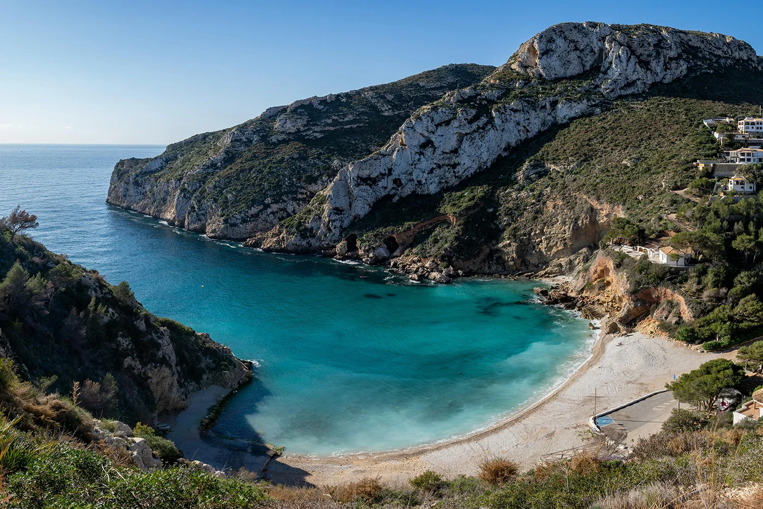 A scenic turquoise cove beach in Javea, Costa Blanca